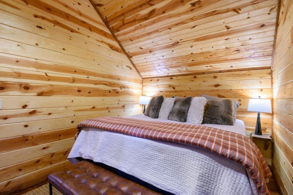 Cozy comforts and woodland dreams in our cabin bedroom.