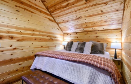 Cozy comforts and woodland dreams in our cabin bedroom.