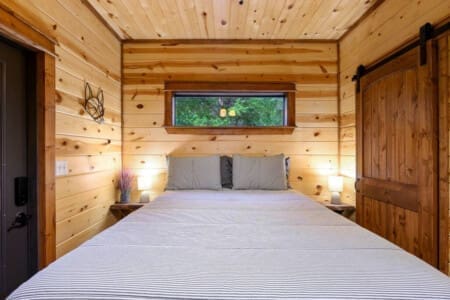 Where every night feels like a forest lullaby: our cabin bedroom.