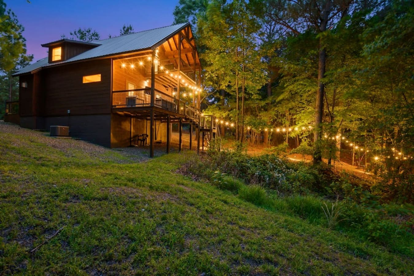 The side view captures the harmony of the cabin with its natural surroundings.