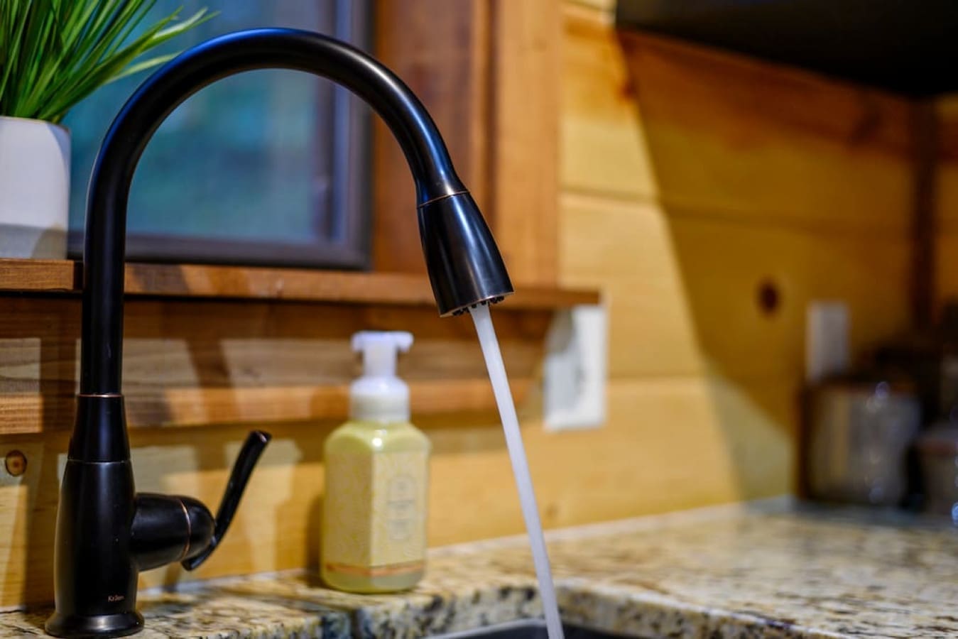 Sleek sophistication flows from our cabin's black faucet.