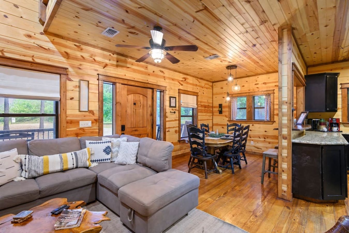 From cozy dinners to fireside chats: Our cabin's inviting living and dining space.
