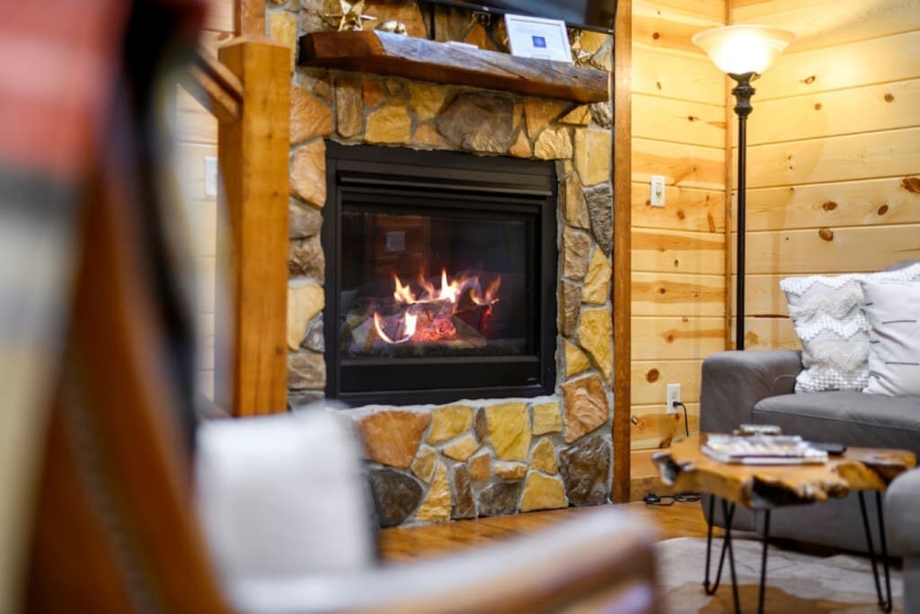 Escape the cold, embrace the warmth: Our cabin's inviting hearth.