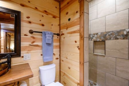 Experience the timeless appeal of wood in our cabin bathroom oasis.