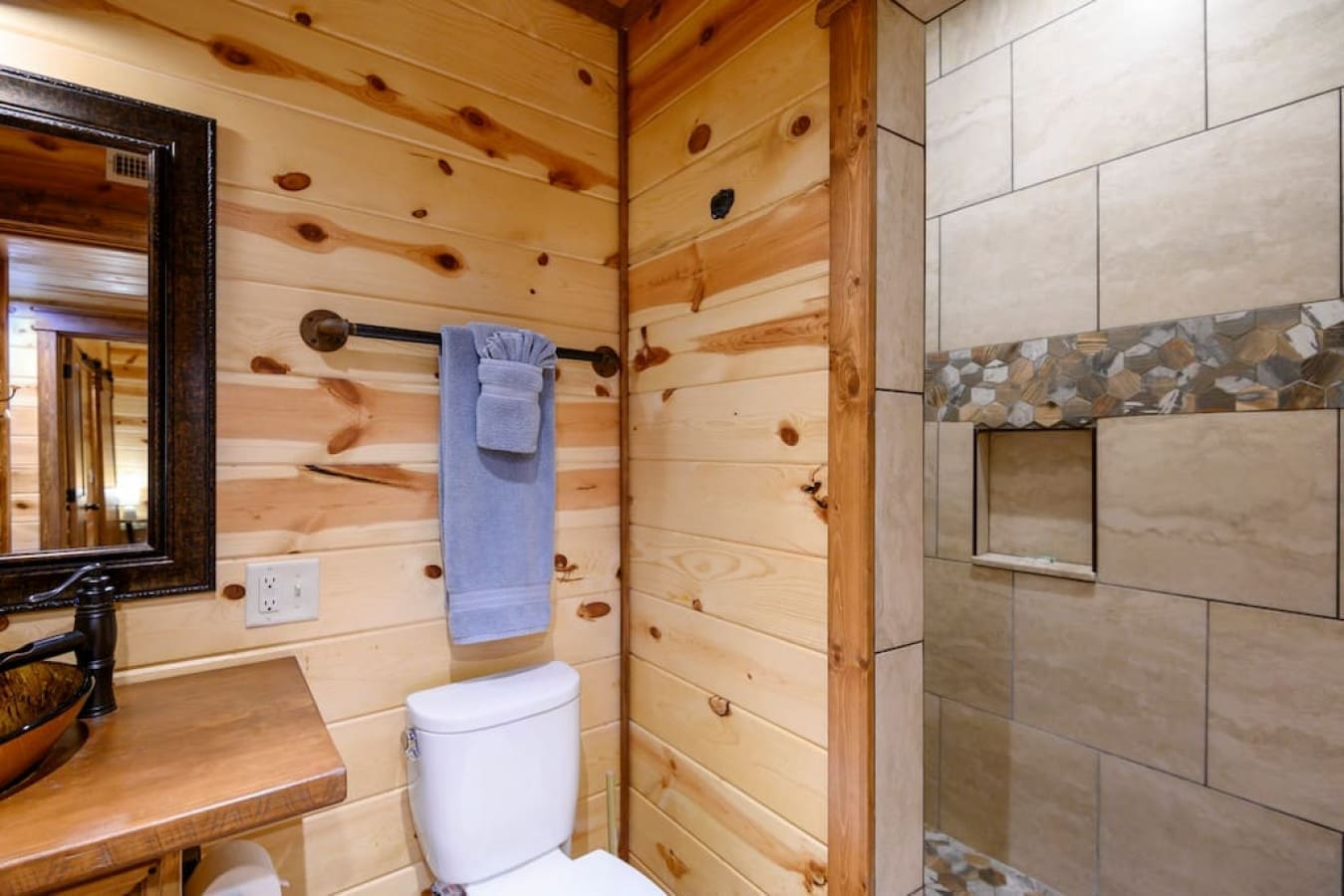 Experience the timeless appeal of wood in our cabin bathroom oasis.