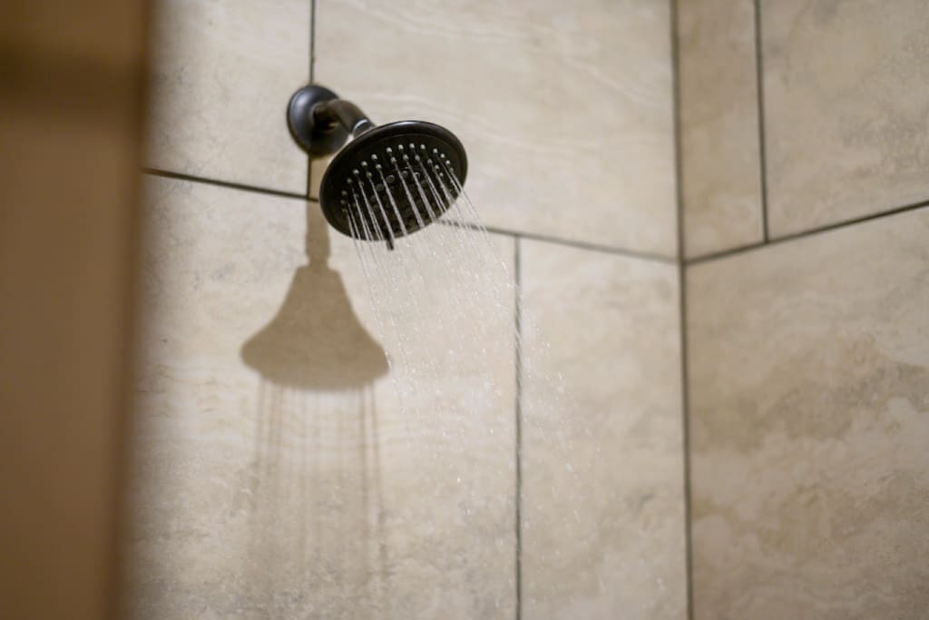 Refresh under the forest's embrace in our cabin shower.