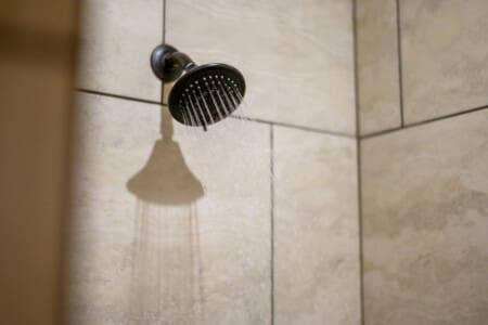 Refresh under the forest's embrace in our cabin shower.