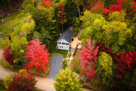 Peak autumn color frames this cottage like a painting you get to live inside.