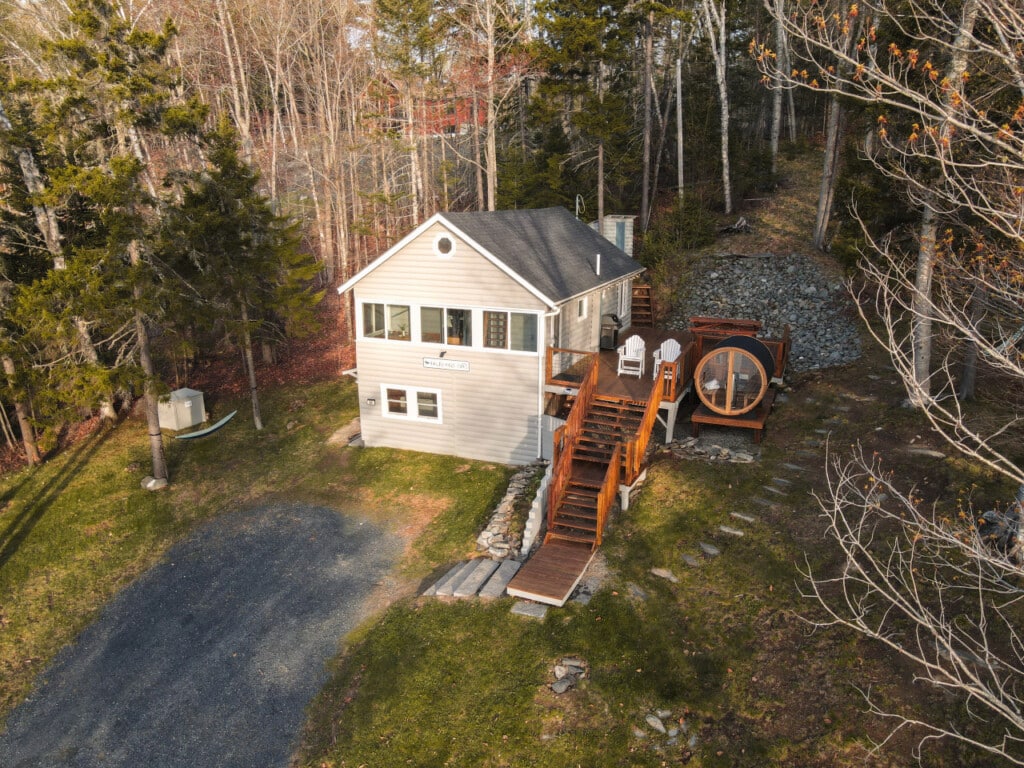 Tucked into the woodland, your full lakeside retreat waits at the top of the stairs.