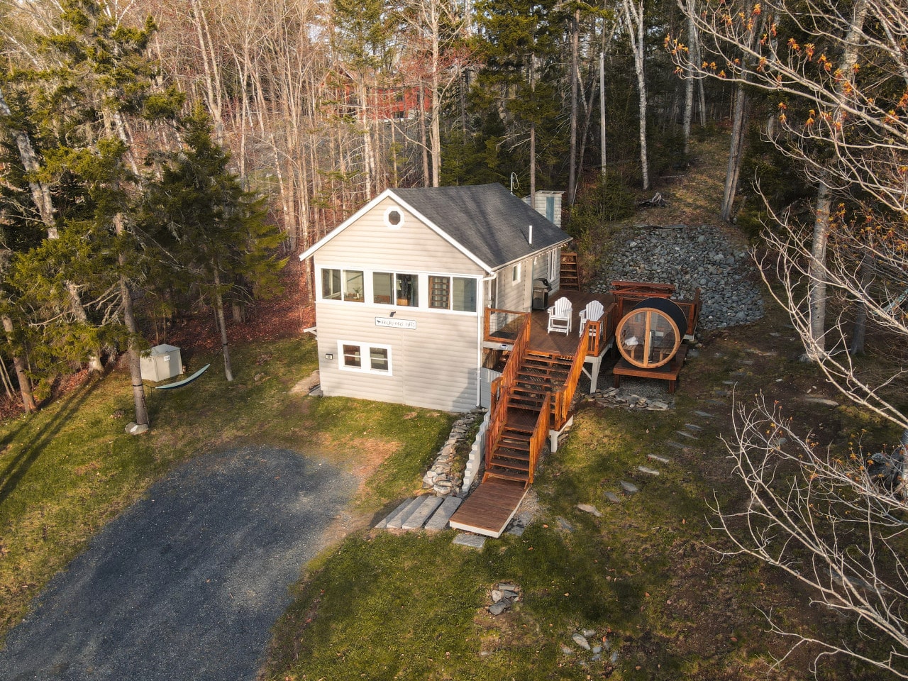 Tucked into the woodland, your full lakeside retreat waits at the top of the stairs.