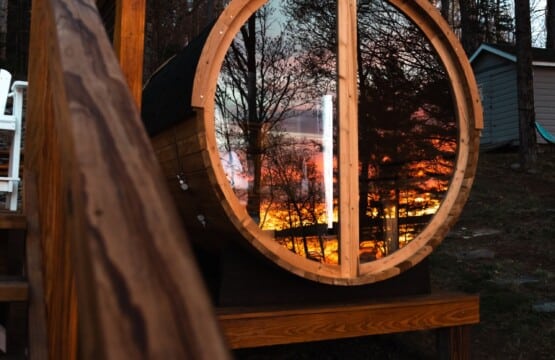 The panoramic sauna window turns a lakeside sunset into your personal masterpiece.