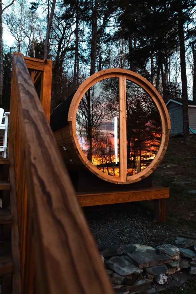 The panoramic sauna window turns a lakeside sunset into your personal masterpiece.