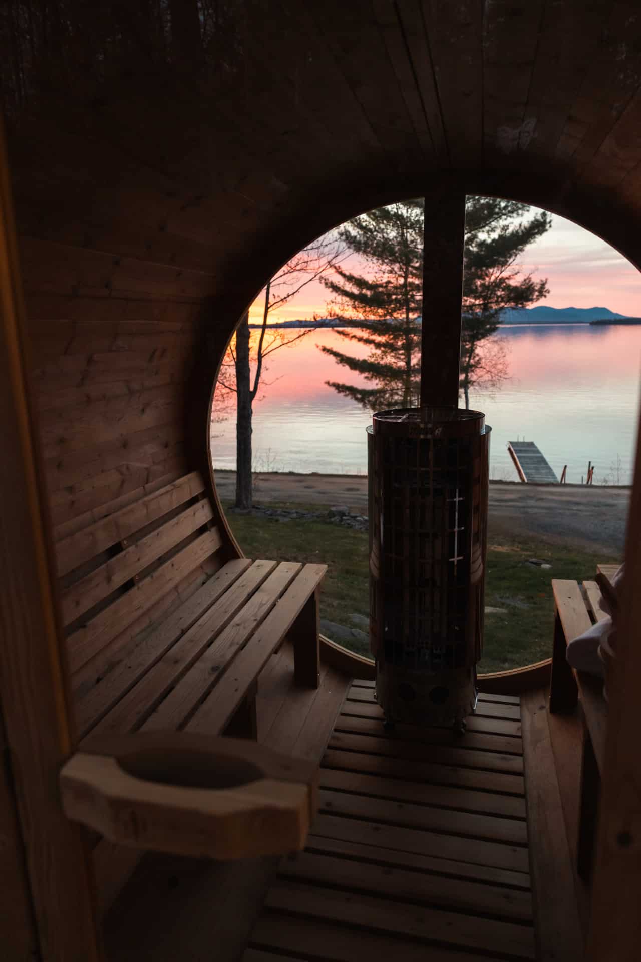 Sweat away the day while a fiery lake sunset fills your private barrel sauna window.