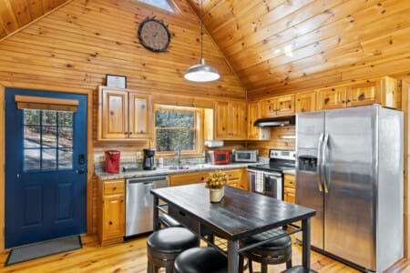 Elevate your cooking experience in our kitchen, where stainless steel shines against the rustic charm of wooden cupboards.