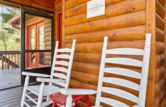 Relaxation in its purest form: White wooden chairs in the cabin retreat.