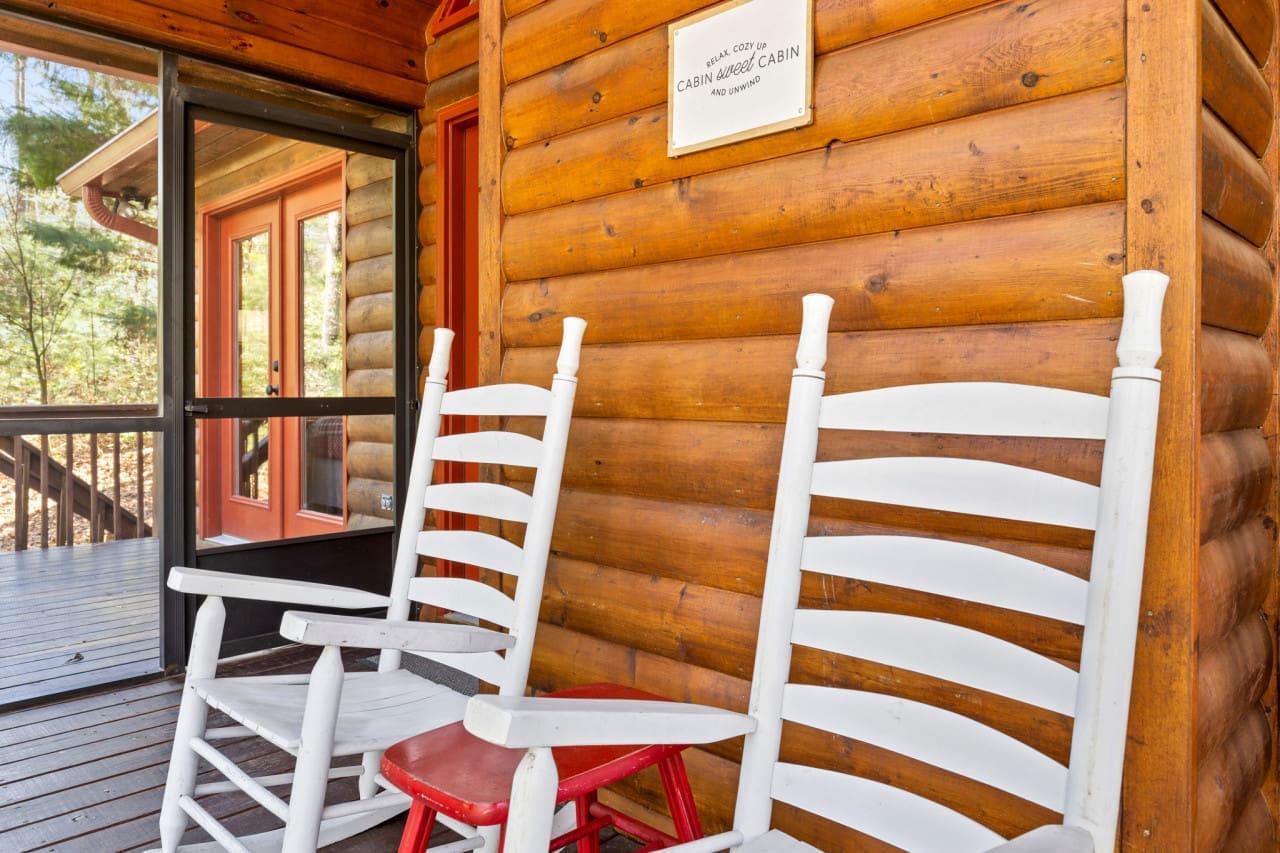 Relaxation in its purest form: White wooden chairs in the cabin retreat.