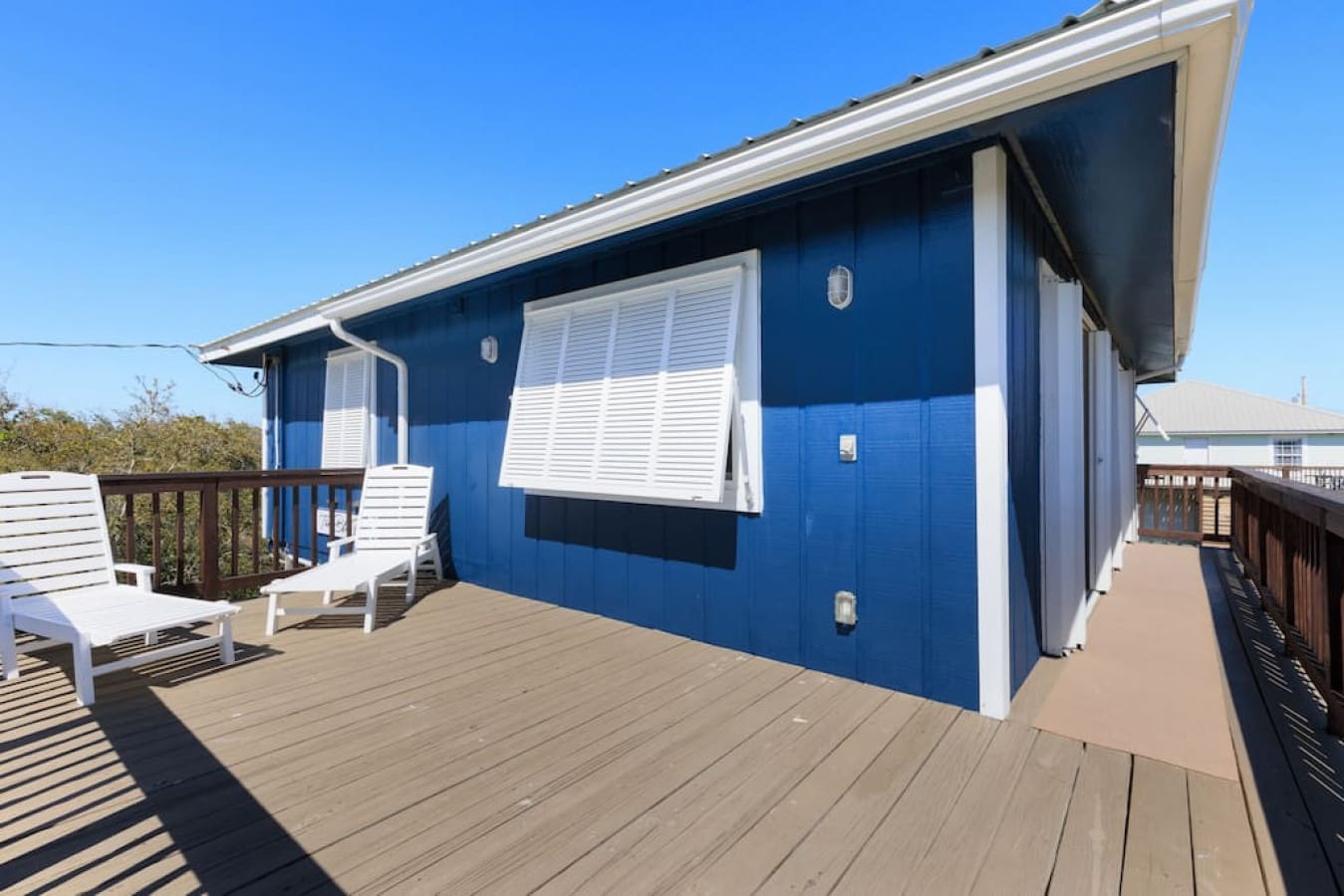 This cheerful blue beauty has a wraparound deck that's basically begging you to spend your entire vacation out here soaking up the sun.
