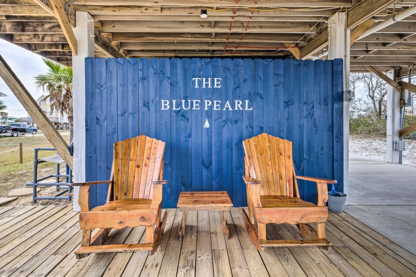 Two comfy wooden chairs waiting for you to park yourself and soak in the view.