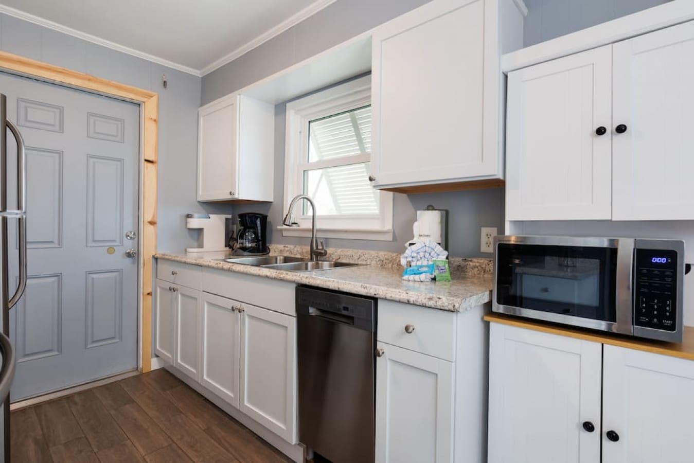 The sleek white kitchen has all the clean lines and granite space you need to actually enjoy cooking (or just pretend to while you're on vacation).