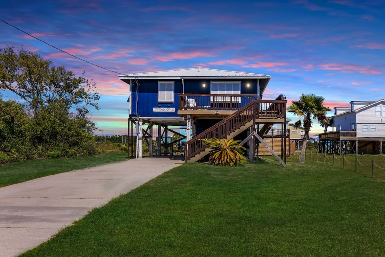 Nothing beats watching the sky turn every shade of pink and orange from your own private blue retreat hanging right over the water.