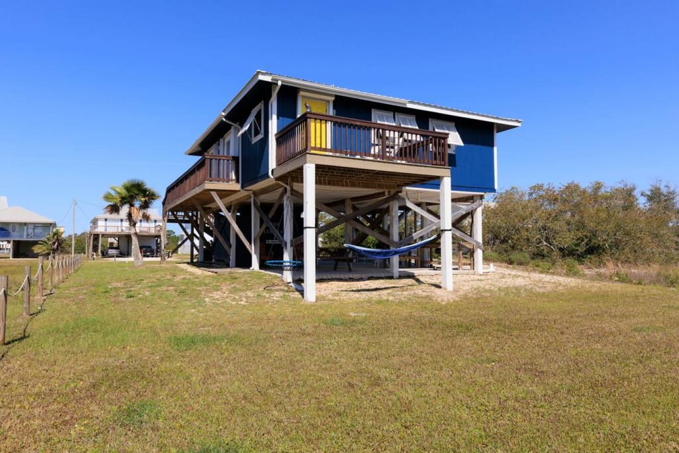 This beachfront beauty perches just high enough to catch all the coastal vibes while those blue touches keep everything feeling breezy and bright.