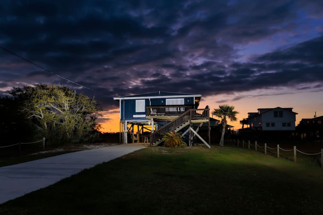 This beachfront stilt house glows like it was made for golden hour—literally right there where the sky meets the water.
