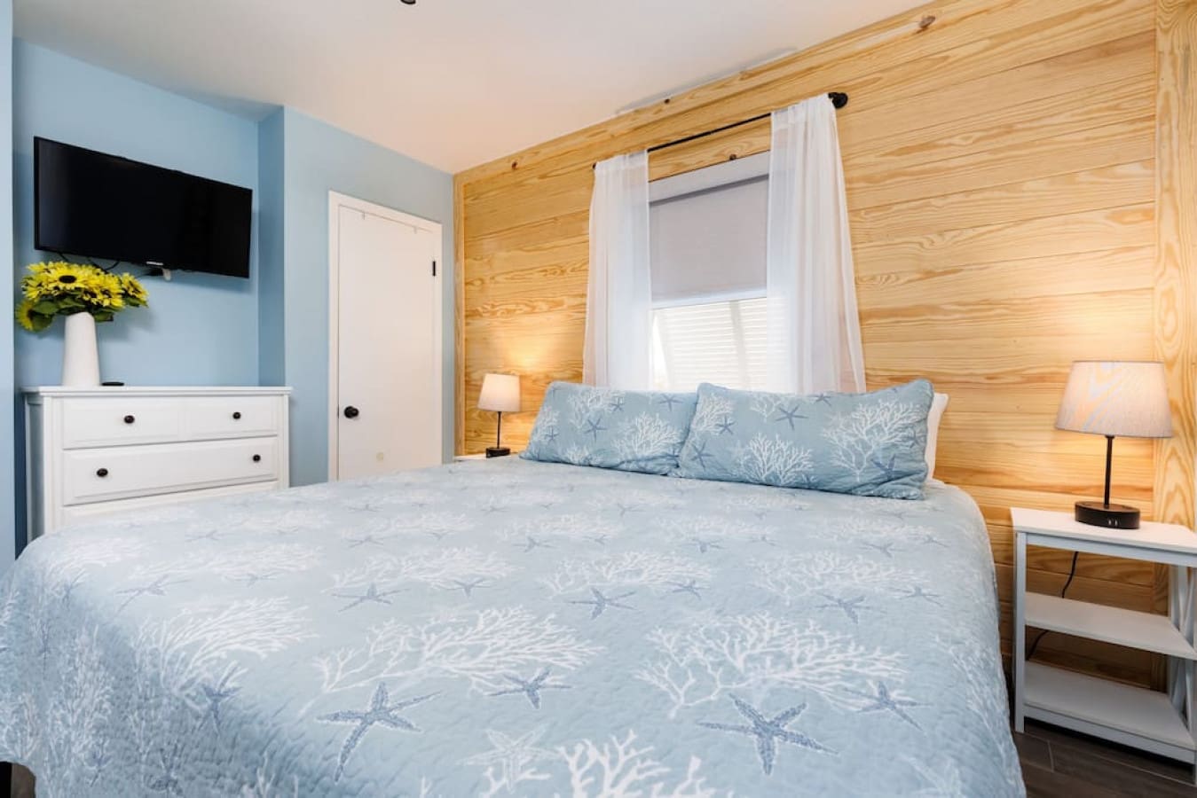 Wake up to that cozy nautical cabin feel with the wood walls wrapping around you like you're sleeping inside a ship.