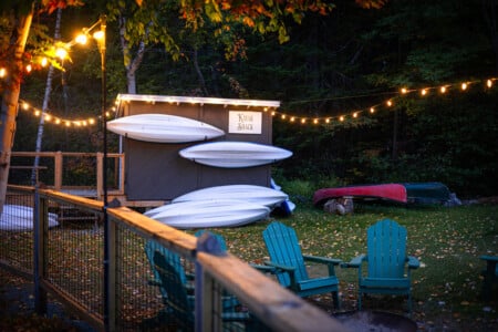 Kayaks waiting, water sparkling.