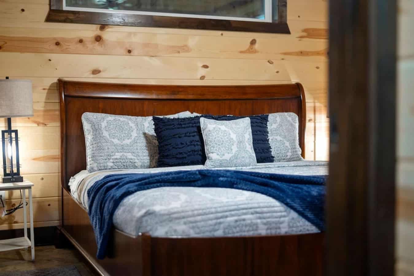 The beds are adorned with cozy pillows and mattresses, accompanied by night lamps on either side for added comfort.