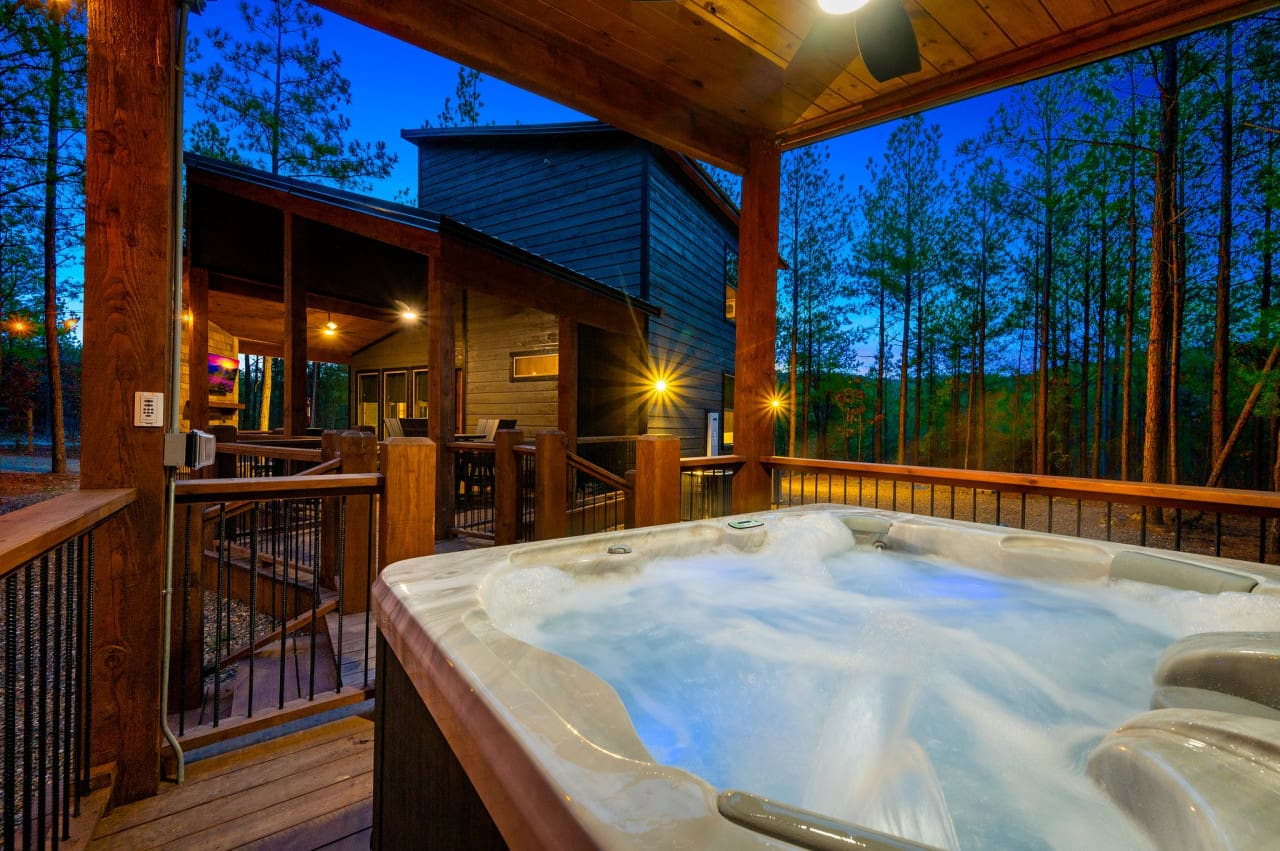 Immerse yourself beneath the starlit sky in the bubbling hot tub and enjoy entertainment outdoors with a dedicated smart TV for an unforgettable experience.