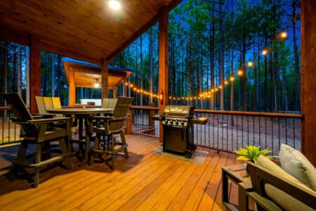 Step onto the spacious patio, adorned with outdoor furniture, a grill, and a warm fireplace beckoning you to relax.
