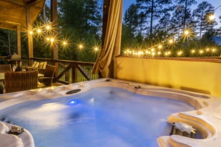 Indulge in Daydream Chalet's hot tub oasis, where you can soak in bliss while basking in the captivating embrace of nature's beauty.