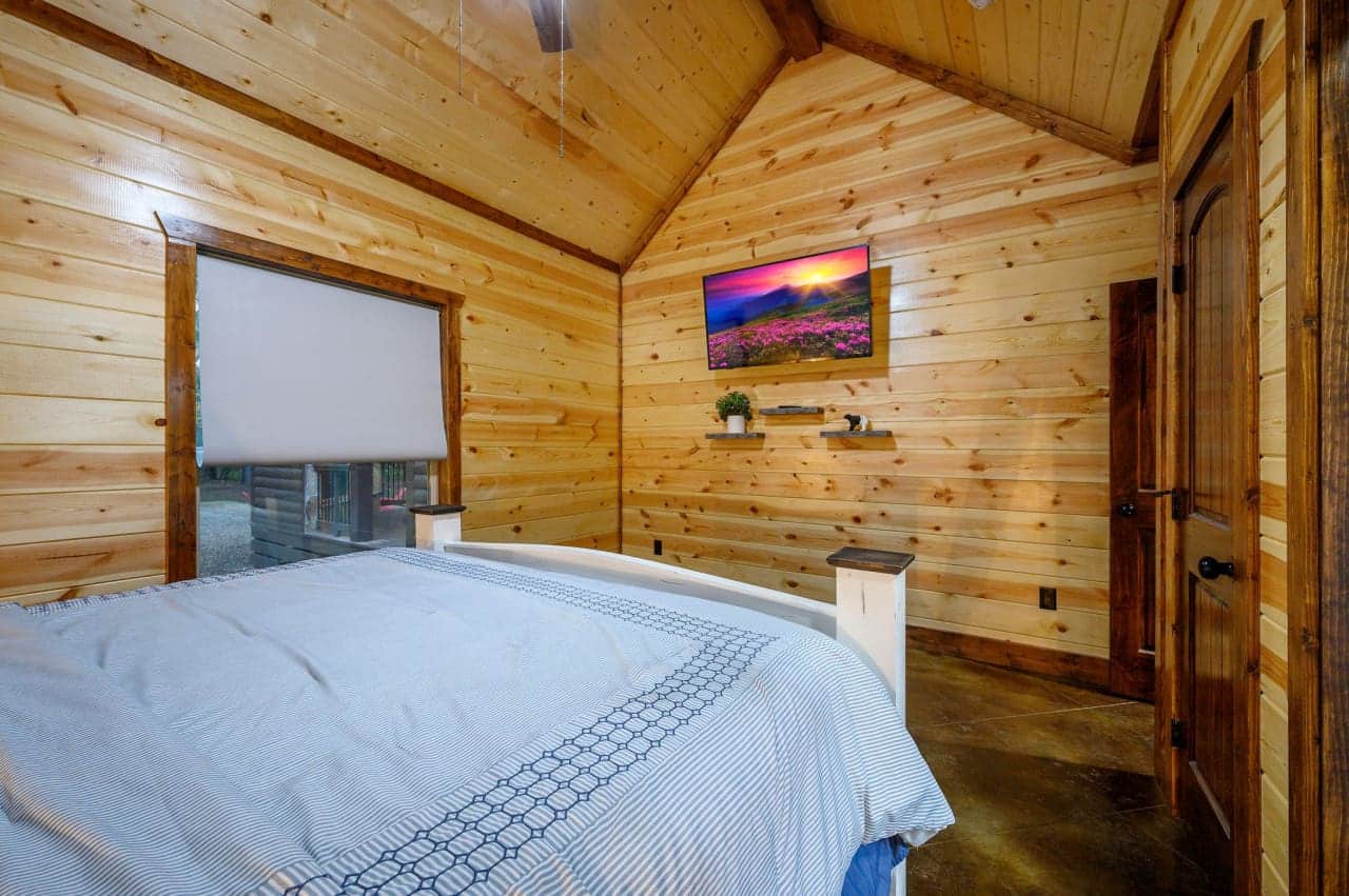 Dream amidst the pines: Our cabin bedroom offers a window to the wild.