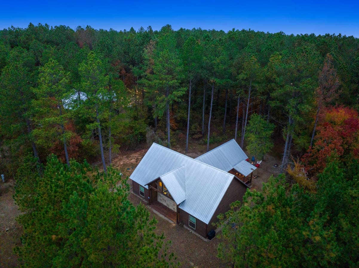 Cabin magic from above: Marvel at the enchanting view of our rustic retreat.