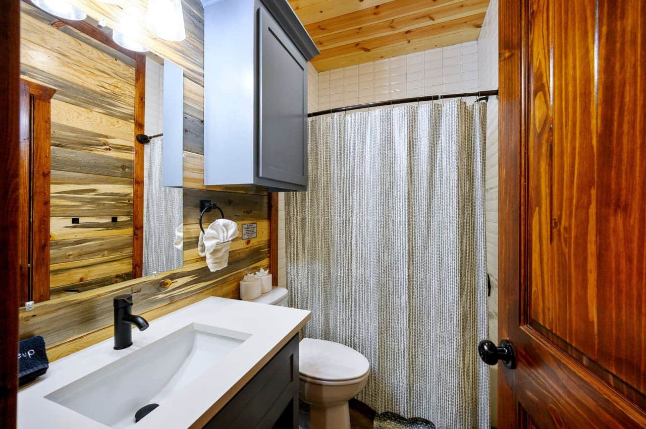 our cabin bathroom with a sleek black faucet.