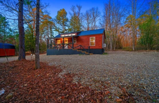 Step into serenity with this rustic cabin retreat featuring a charming balcony. Let the rhythmic rustling of leaves and the distant calls of wildlife be your soundtrack, creating the perfect harmony for a peaceful getaway.