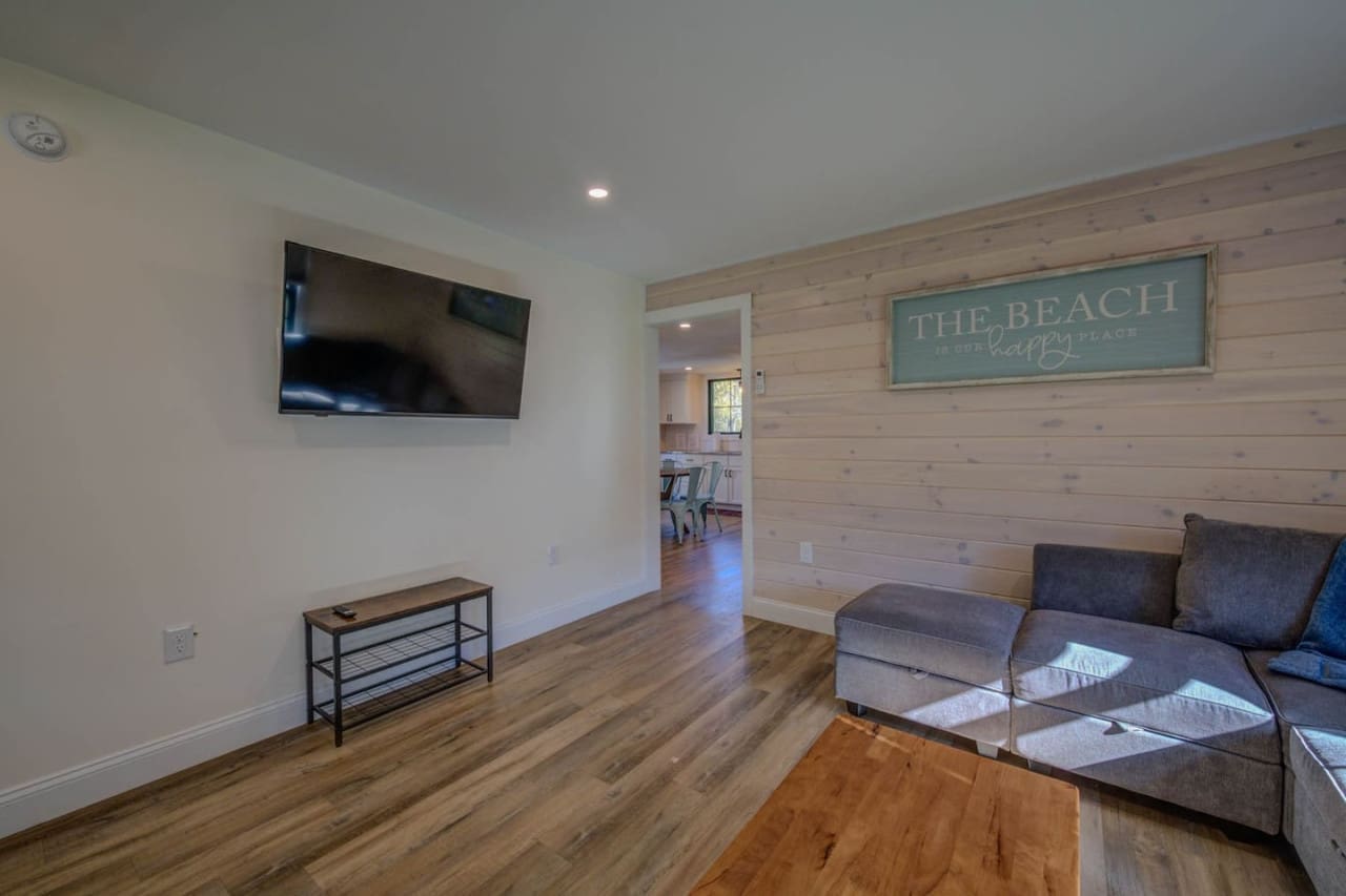 Our living room boasts a sleek flat screen on the wall, transforming movie nights into immersive experiences and bringing joy to every moment.