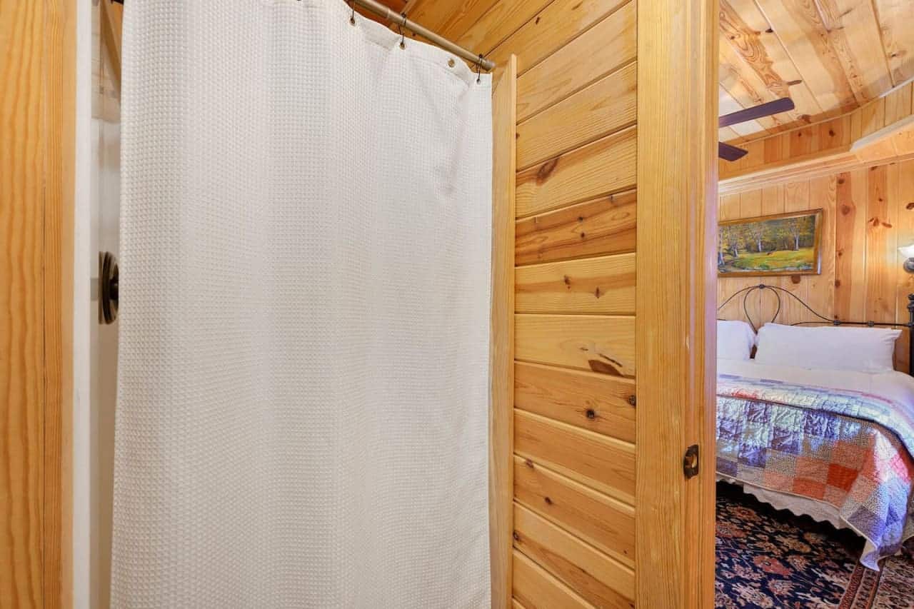 Where privacy meets wilderness in the cabin's shower corner.Find solace in simplicity at this cabin bathroom.