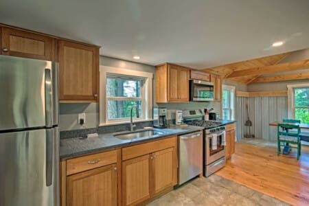 Sophisticated Simplicity: Where Wooden Cupboards and Stainless Appliances Harmonize Effortlessly