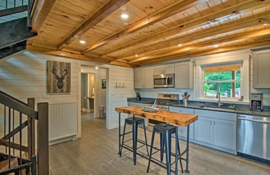 Modern Rusticity: Where Grey Cupboards and Wooden Ceilings Blend in Kitchen Harmony