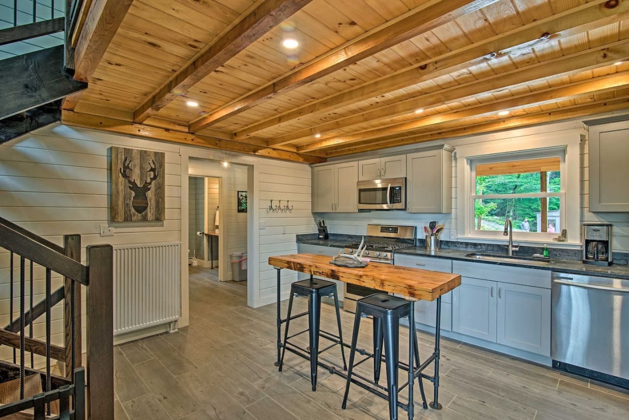 Modern Rusticity: Where Grey Cupboards and Wooden Ceilings Blend in Kitchen Harmony