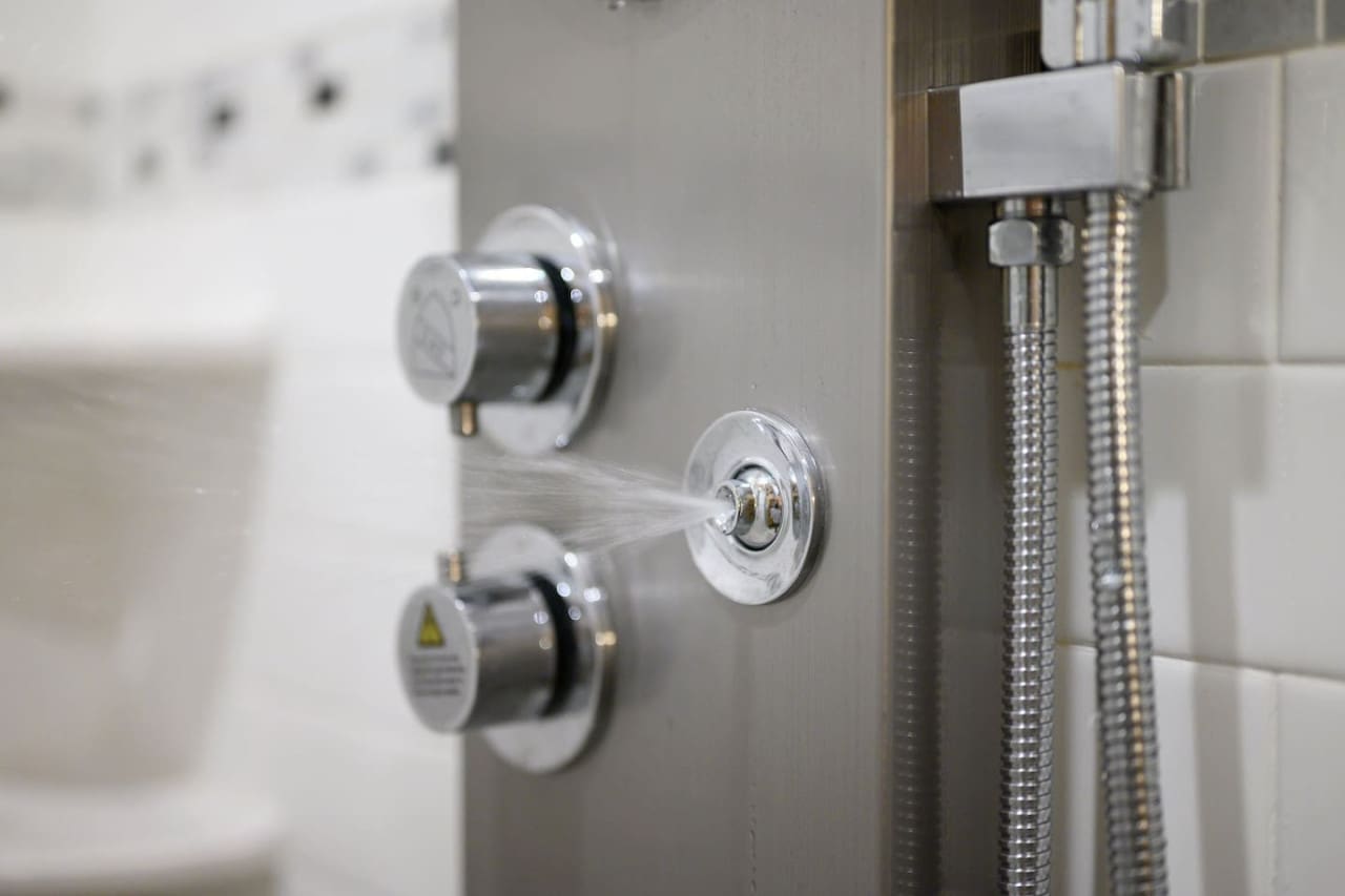 You've got multiple shower heads and a rainfall showerhead situation going on—basically a spa experience tucked into this bathroom.