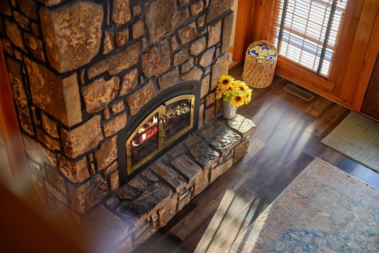 Experience the rustic beauty and inviting glow of our stunning stonewall fireplace.