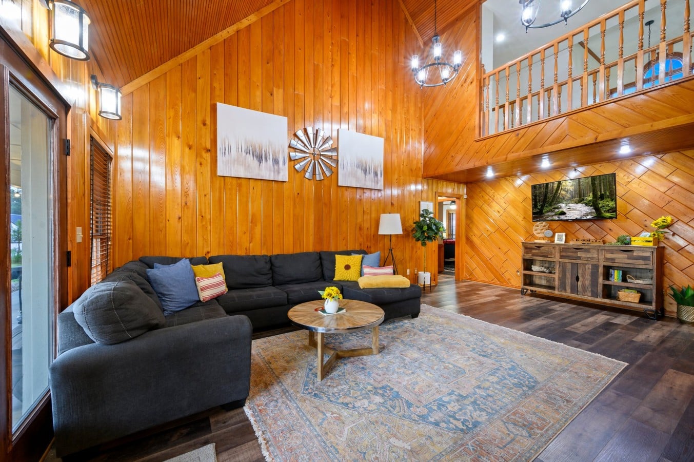 Two-story living room with fireplace and upstairs loft view.