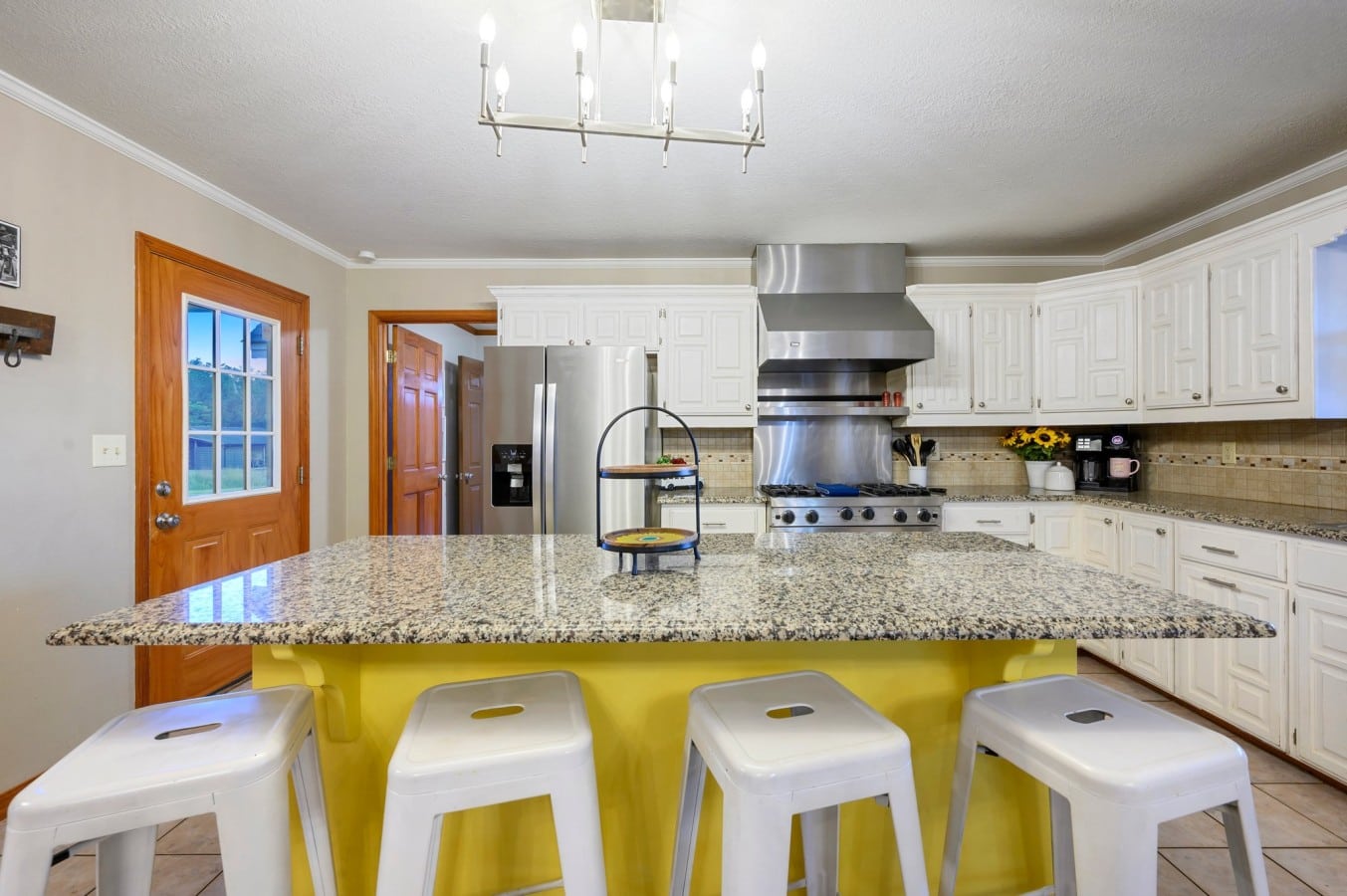 Kitchen island seating with stainless appliances nearby.