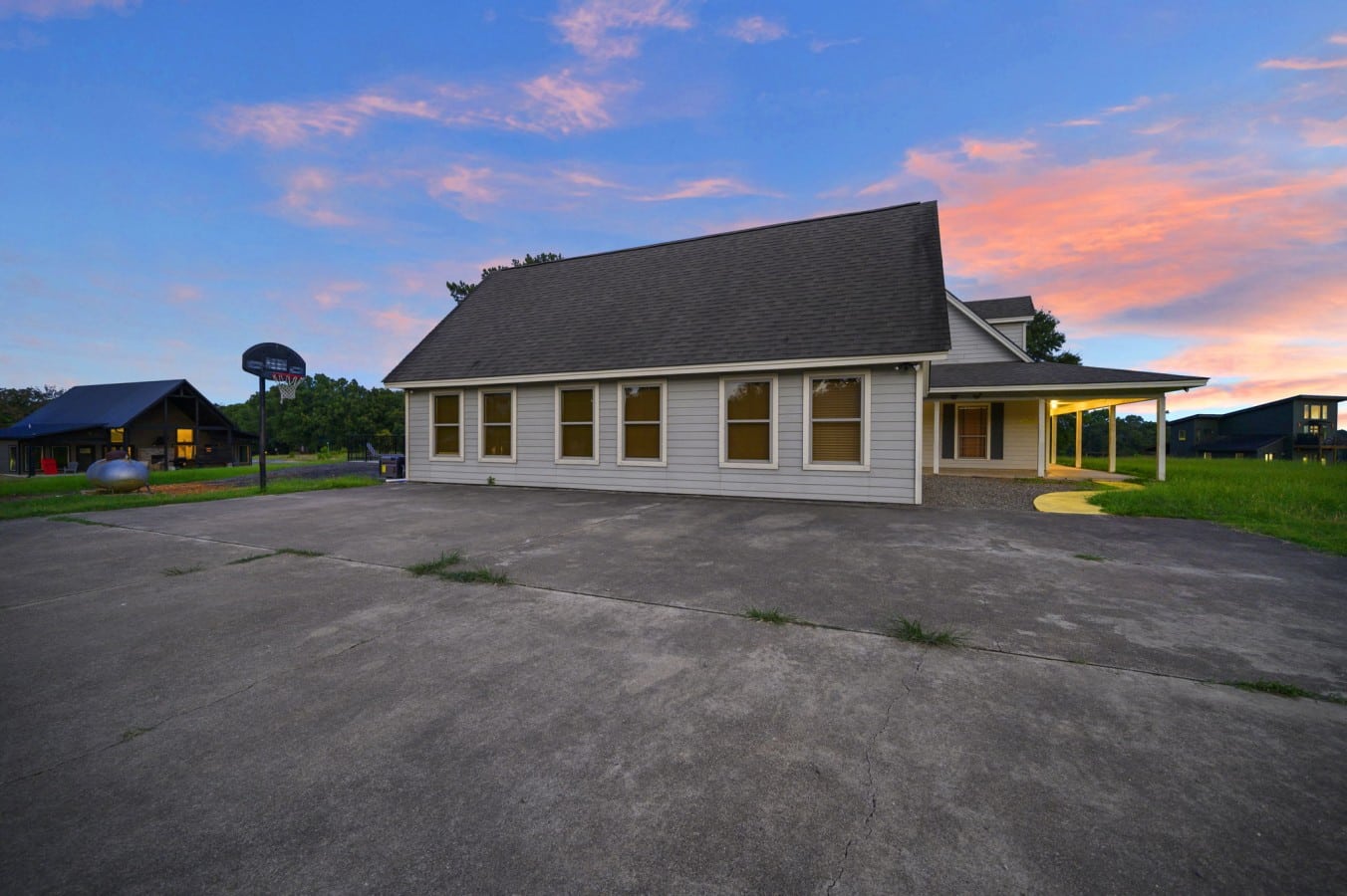 Side exterior showing the wide parking area and cabin footprint.