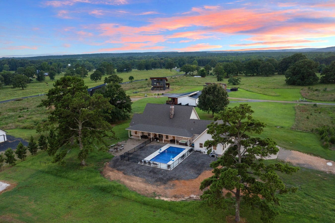 Aerial view showing the cabin, pool, and rural surroundings.