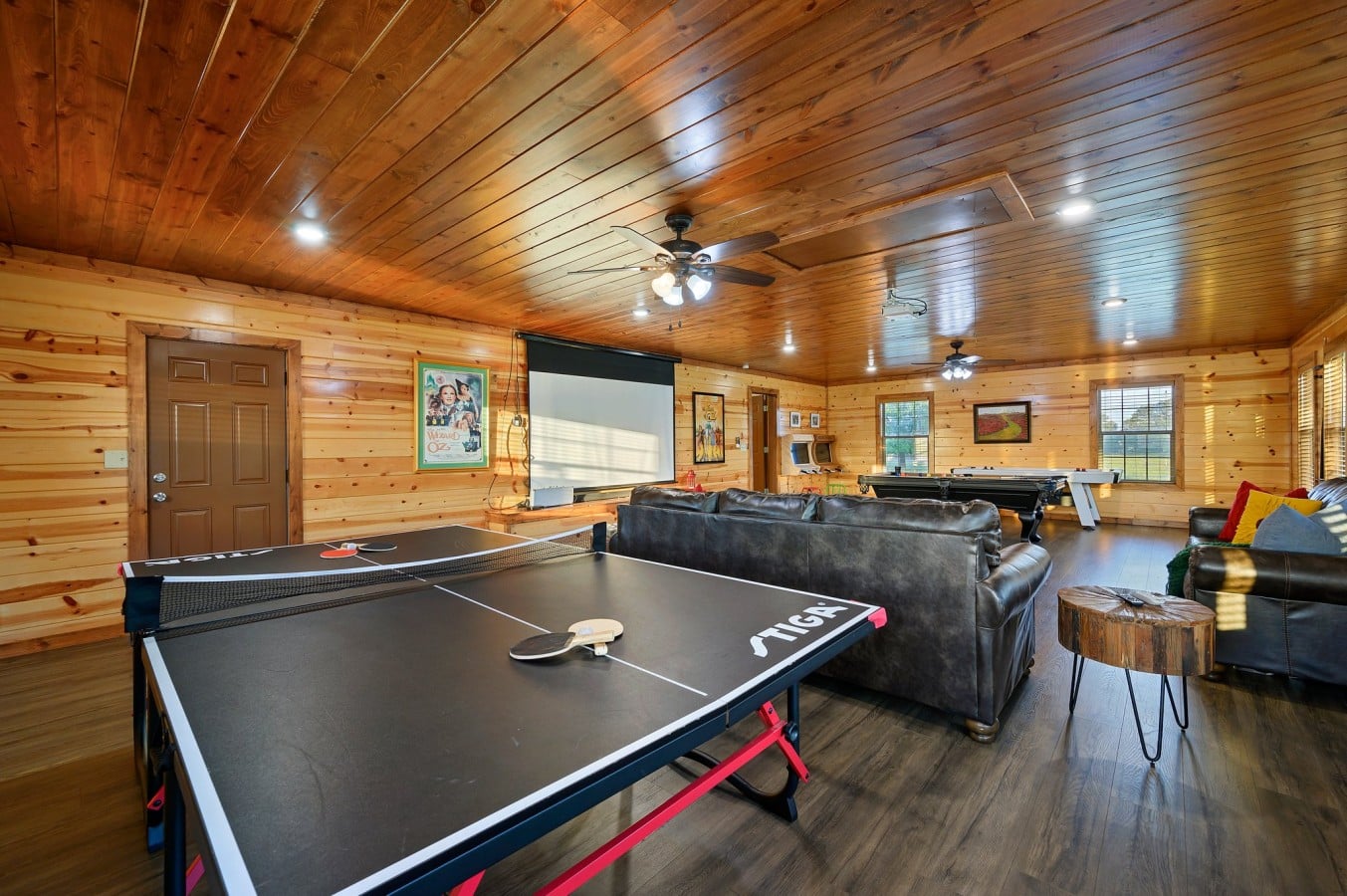 Large game room with pool table, ping pong, and lounge seating.