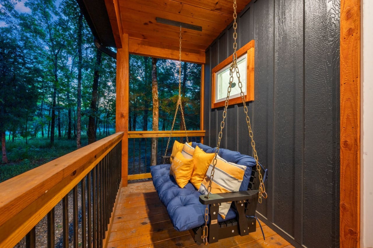 Elevate your outdoor experience with a cozy swing chair on the balcony, perfect for serene moments.