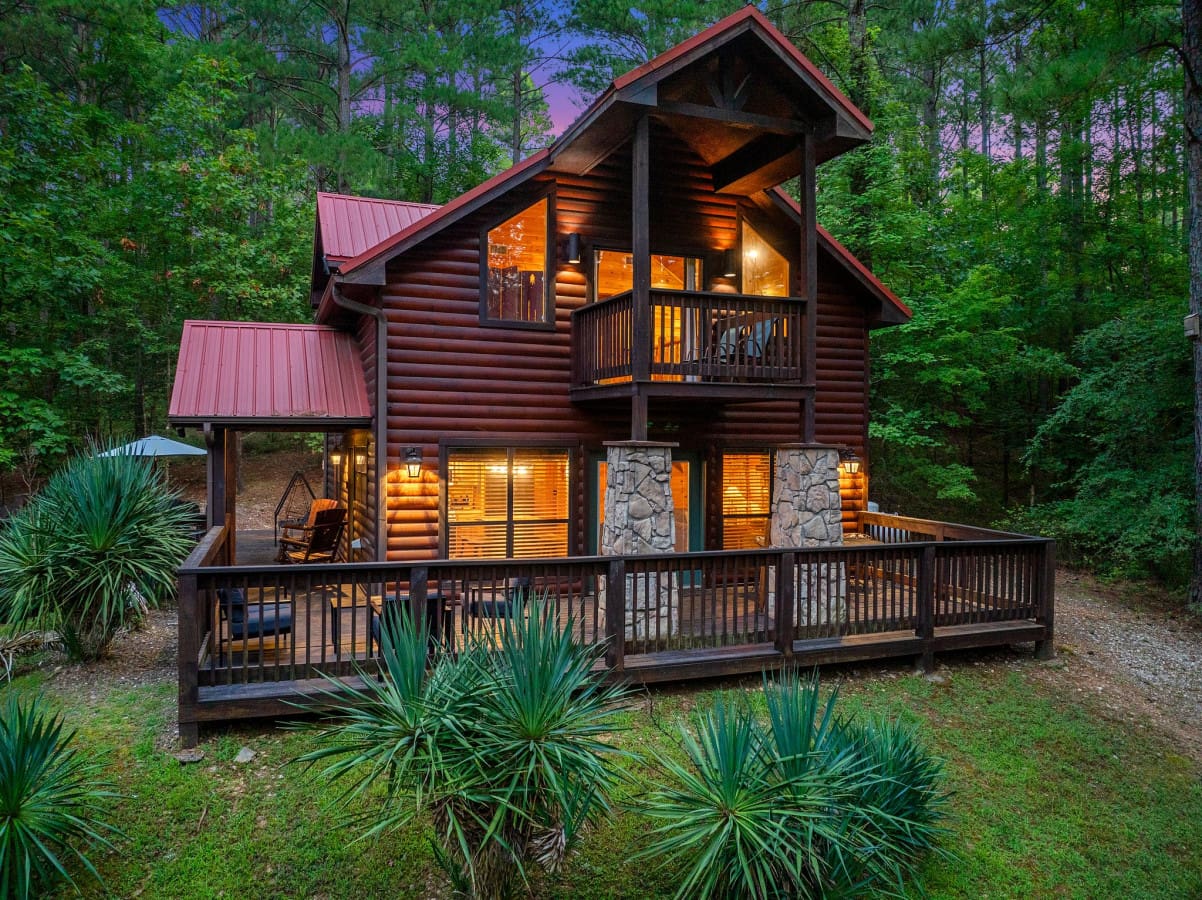 Discover the hidden charm of our cabin's secluded back view, surrounded by nature.